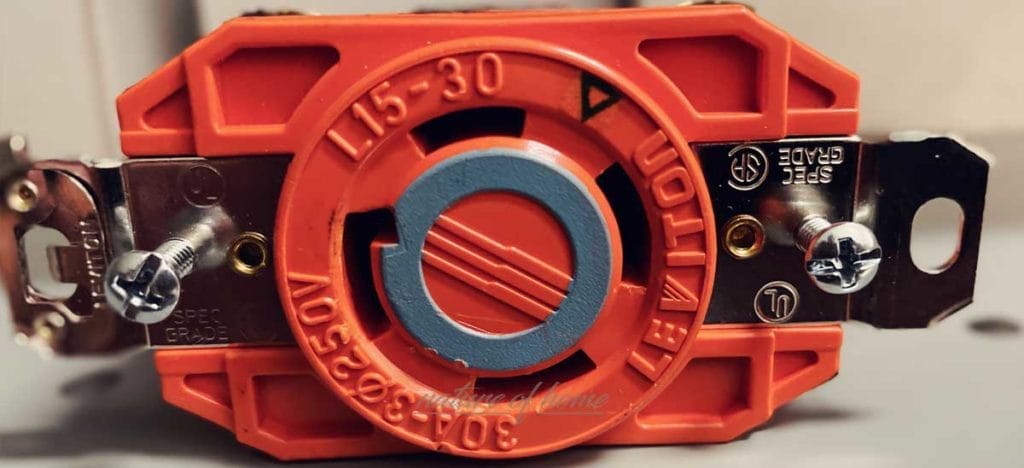 Orange Electrical Outlets 2 Orange electrical outlet for commercial settings with a twist-lock design.