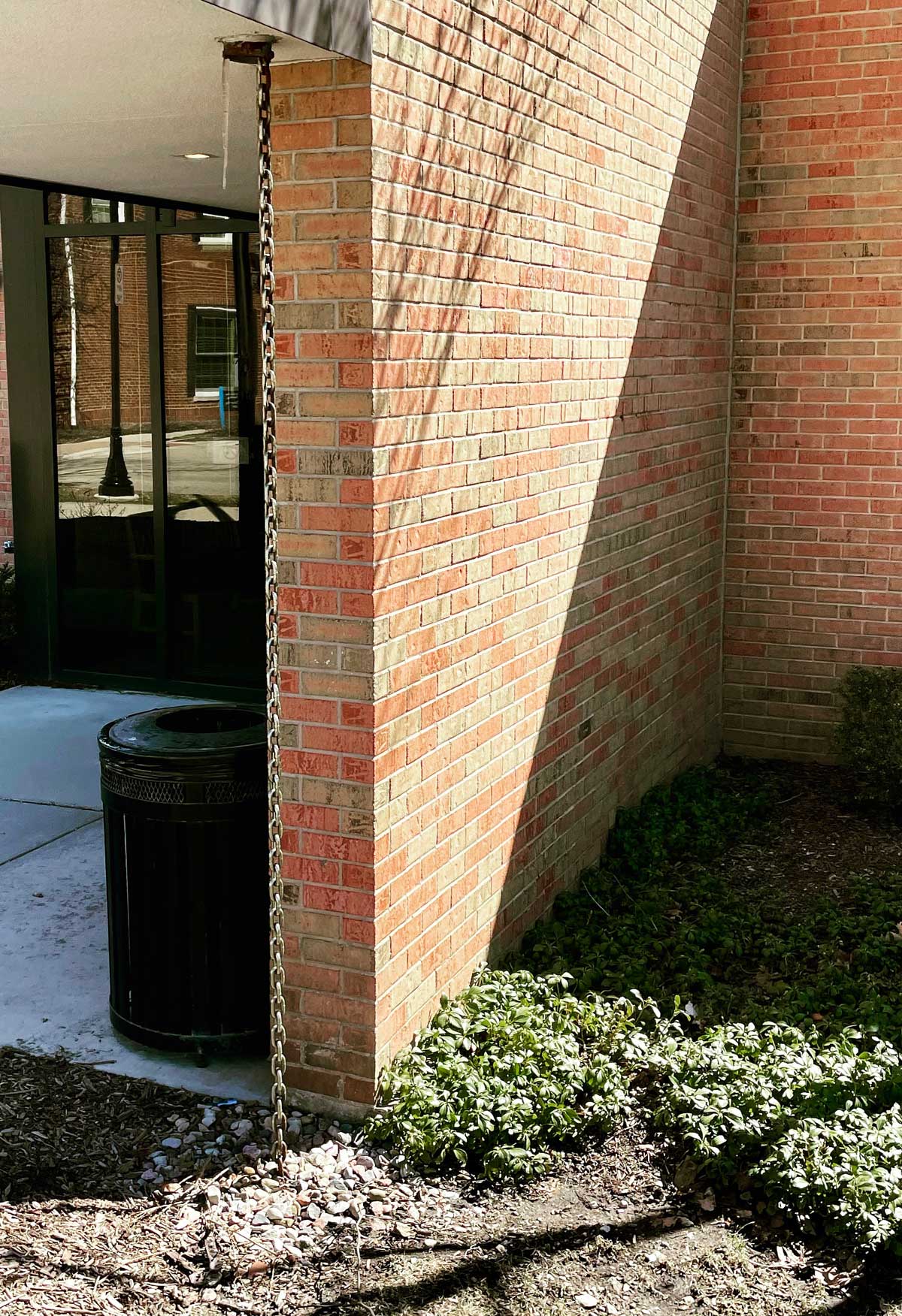 Rain Chains: What They Are + Why You Need One + How to Make Your Own 5 rain chain on a brick building