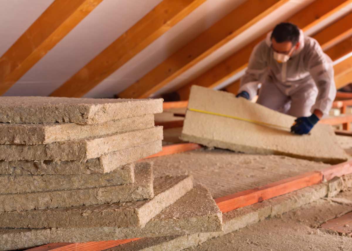 Insulating an Attic: Benefits, How-to & Tips 3 installing insulation in an attic