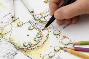 Landscape Designer vs. Landscape Architect (Differences + Which One Should You Hire?) 1 landscape designer or architect making a plan