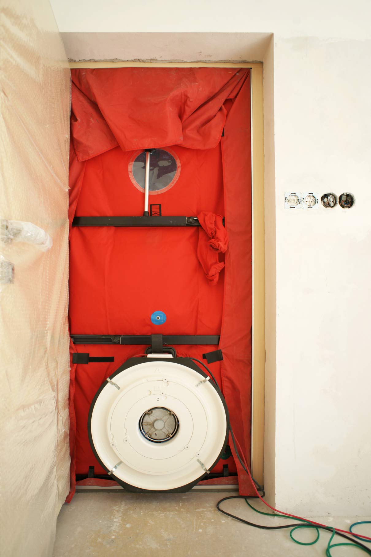 Thermal Envelope Design in Home Building (Explained) 2 blower door testing a home for air-tightness