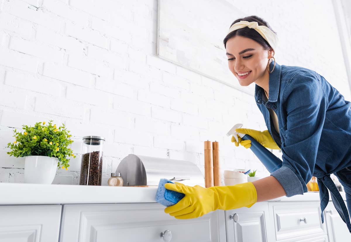 5 Simple Ways to Bring the Beauty of Spring into Your Home 4 woman cleaning kitchen