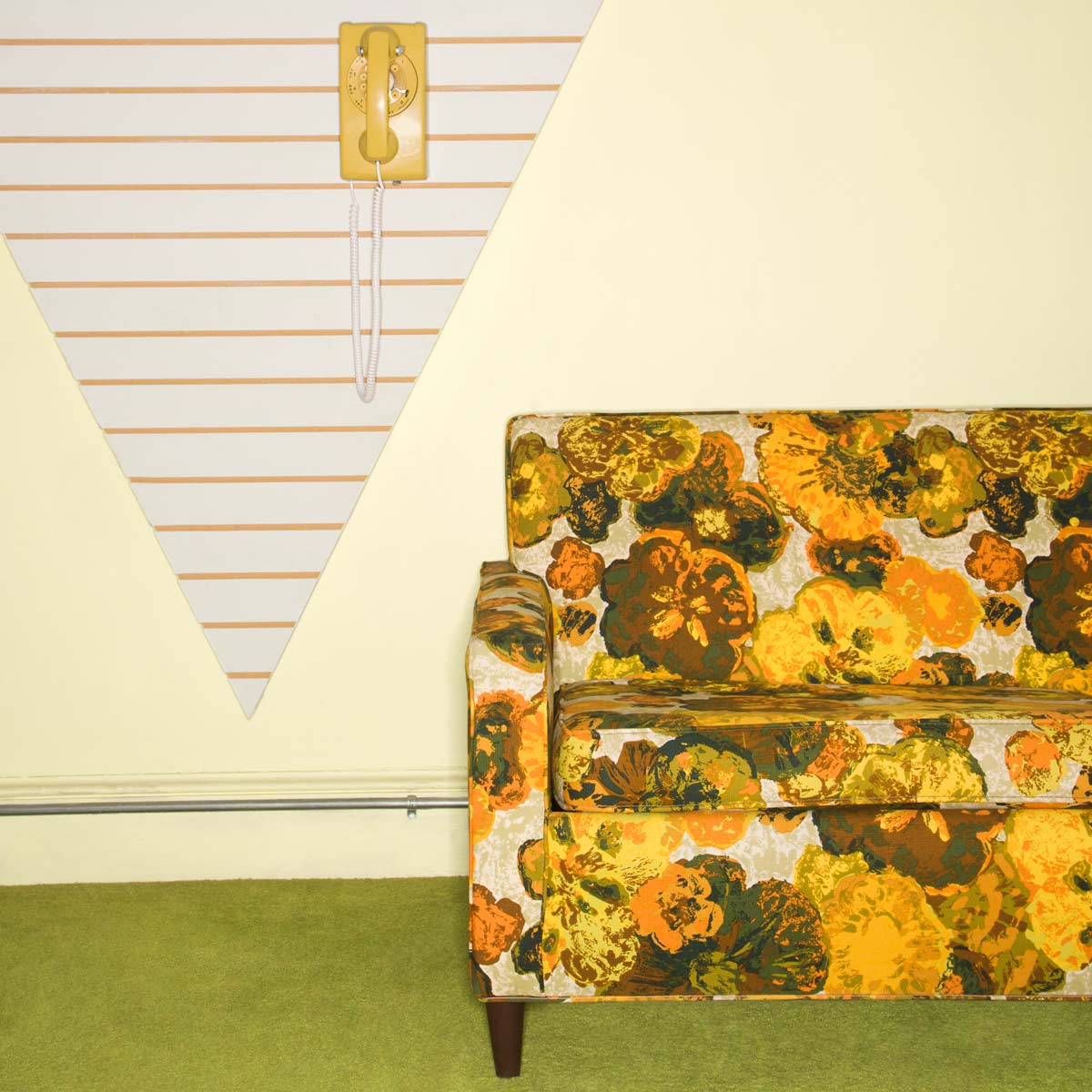 16 Things in 70s Homes: Cringeworthy & Loved Come Back Items 12 old floral couch and wall phone.