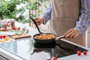 Delicious Creamy Cajun Chicken Pasta 1 woman cooking cajun chicken pasta