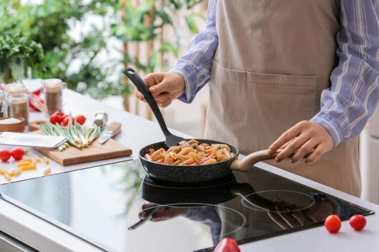 Delicious Creamy Cajun Chicken Pasta 4 woman cooking cajun chicken pasta