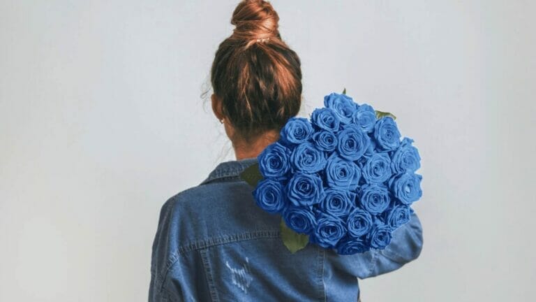 Blue Rose Meaning: Color + Symbolism Explained 1 woman with blue roses wondering what they mean