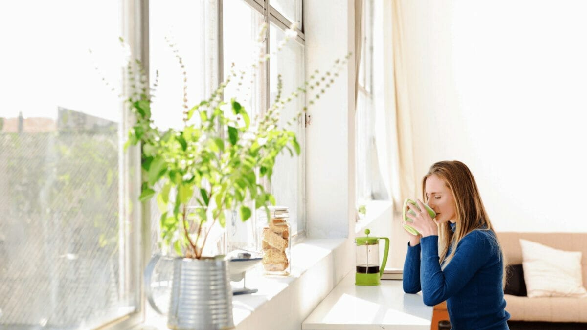 5 Simple Ways to Bring the Beauty of Spring into Your Home 2 woman window sunshine