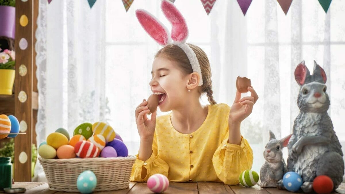 child eating an easter egg with dye
