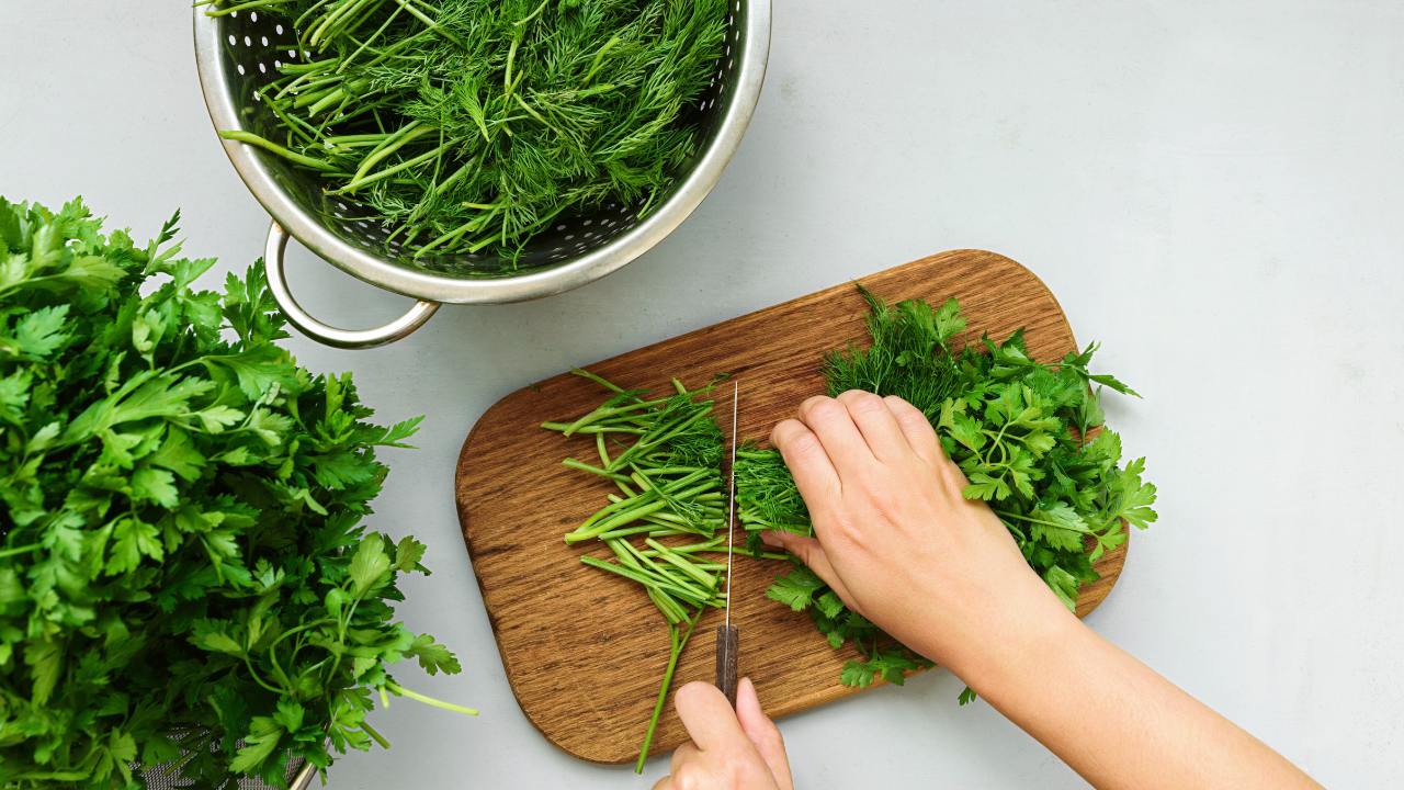 7 Popular Green Herbs: What They Are & How to Use Them 11 cutting fresh green herbs