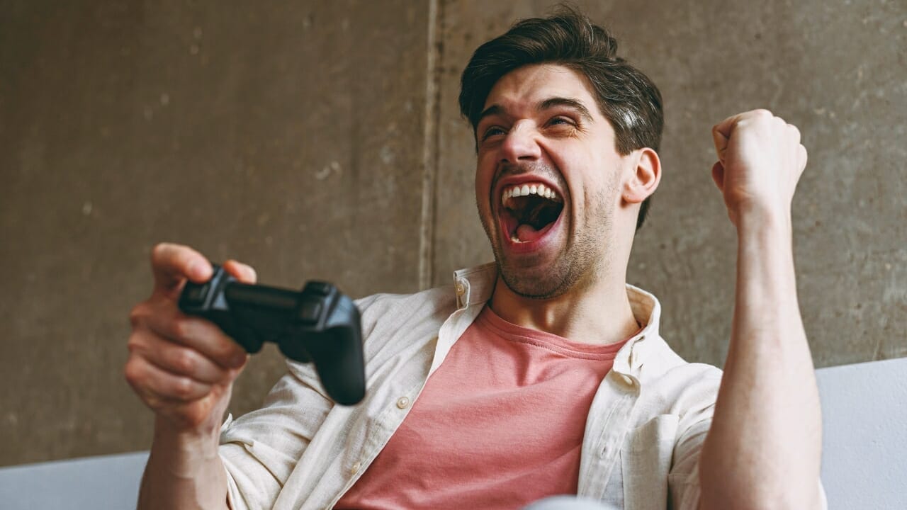 23 Energy-Guzzling Household Devices Spiking Your Electricity Bill 15 23 Energy-Guzzling Household Devices Spiking Your Electricity Bill - man playing video games ss2113243037