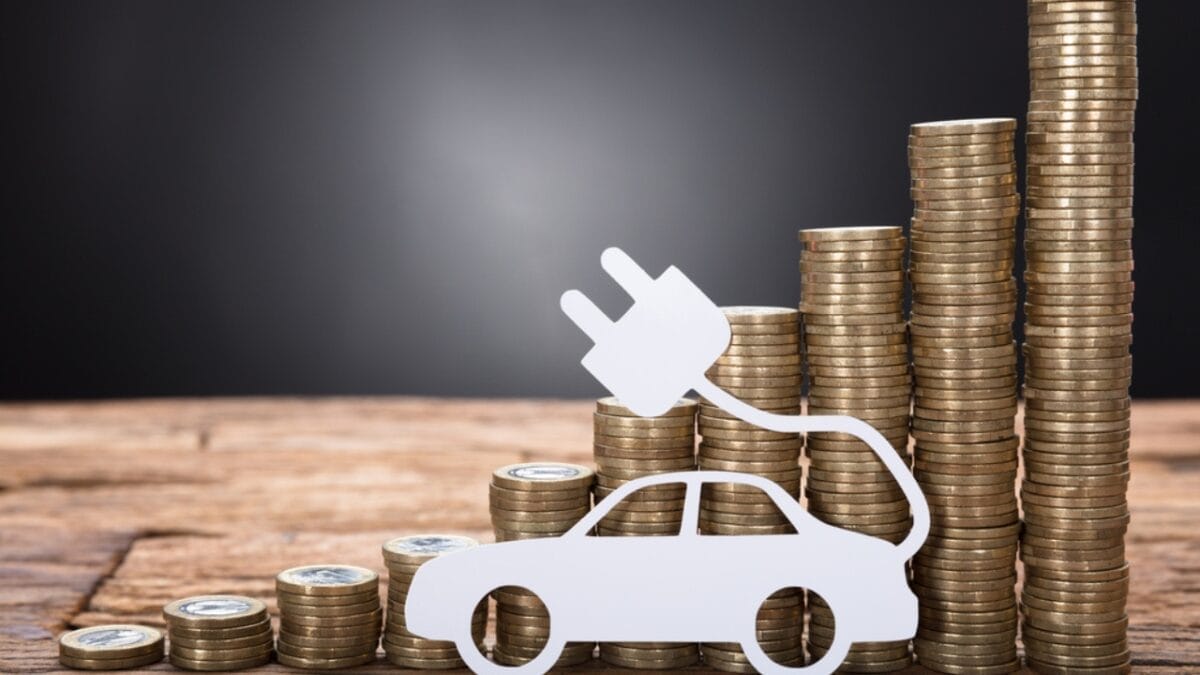 Thinking of Buying an EV? Watch Out for These 10 Hidden Fees 10 Thinking of Buying an EV? Watch Out for These 10 Hidden Fees - car stacked coins ss699106771