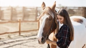 10 of the Cheapest Horses to Keep as Pets 1 10 of the Cheapest Horses to Keep as Pets - horse with woman ss741055474