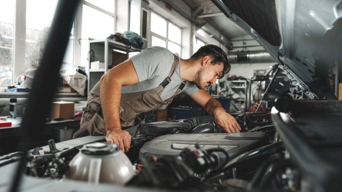 Thinking of Buying an EV? Watch Out for These 10 Hidden Fees 7 Thinking of Buying an EV? Watch Out for These 10 Hidden Fees - man examining hood car ss2293019305