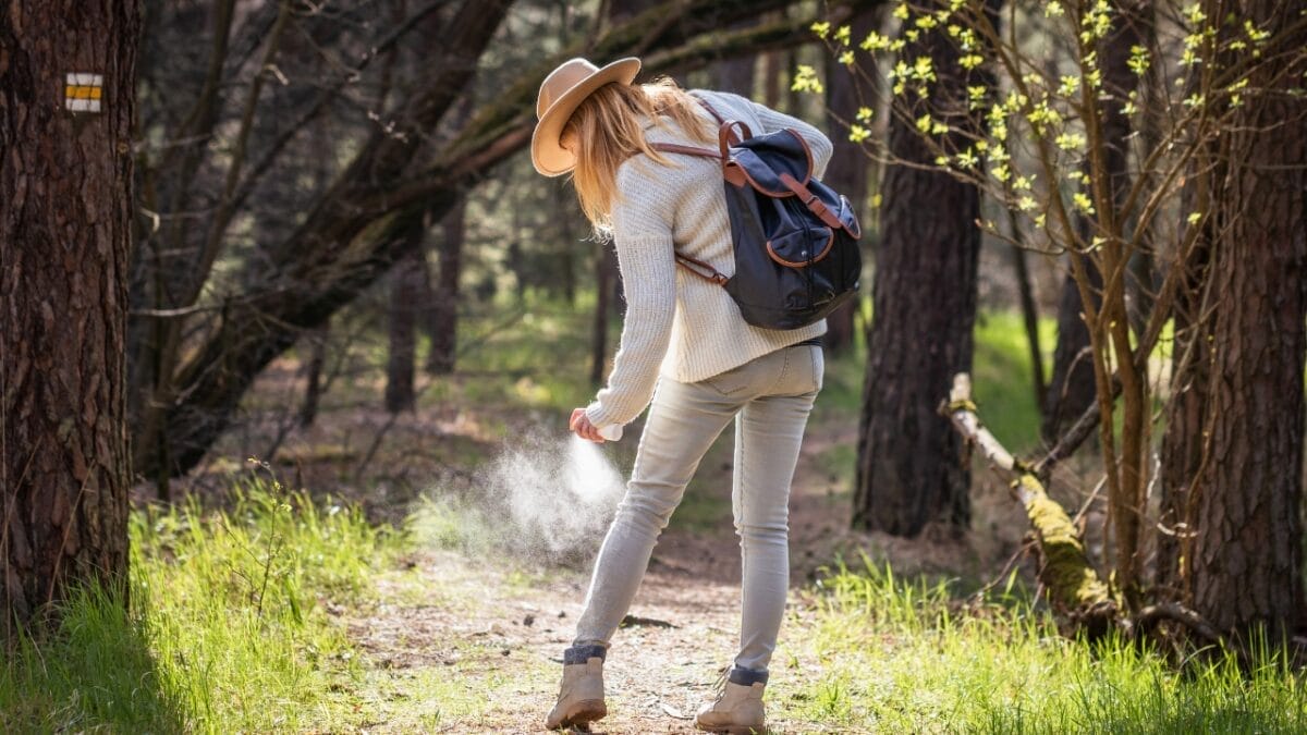 With Up to 128 Spider Species in Your Home, Use These 12 Natural Ingredients to Keep Them Out - woman spraying insect repellent ss1964490115