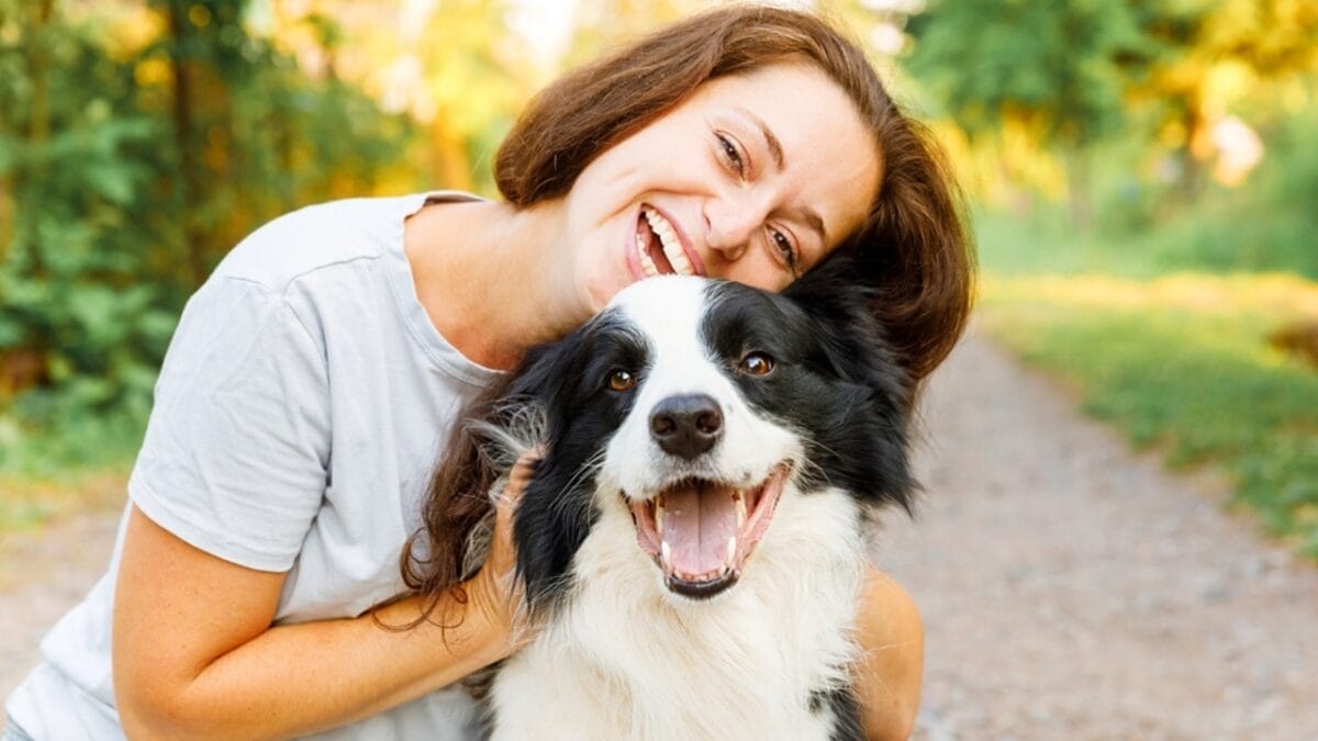 These 17 Dog Breeds are Perfect for Snuggling & Emotional Support - woman hugging border collie dog ss2143257093