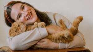 9 Lives, 9 Health Benefits: How Cats Can Extend Your Lifespan 1 9 Lives, 9 Health Benefits: How Cats Can Extend Your Lifespan - woman hugging cat baby ss2399908173
