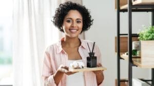 Busting Bad Vibes: 10 Tips to Restore Positive Energy in Your Home 1 Busting Bad Vibes: 10 Tips to Restore Positive Energy in Your Home - woman with diffuser dp530708548