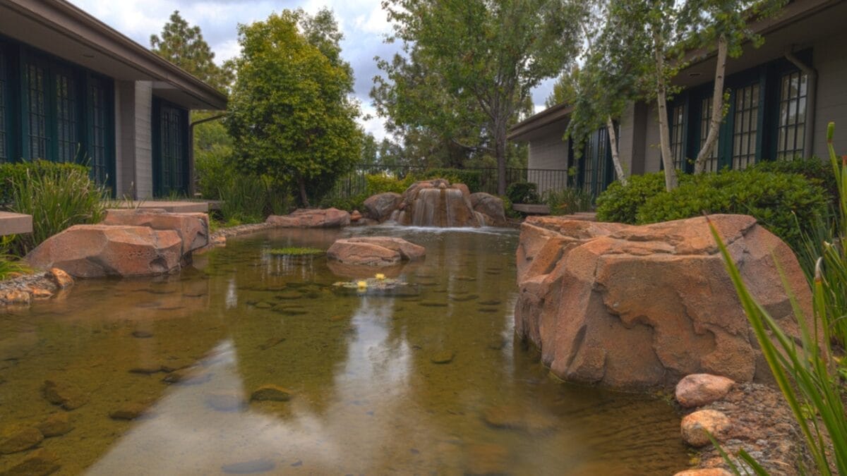 Zen & the Art of Rock Placement: 21 Tranquil Boulder Landscaping Ideas 7 Zen & the Art of Rock Placement: 21 Tranquil Boulder Landscaping Ideas - Large Rock in Pond dp108985522