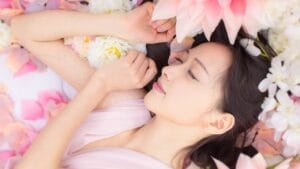 14 Sleep-Enhancing Bedroom Plants 1 14 Sleep-Enhancing Bedroom Plants - asian girl with flower ss209036044