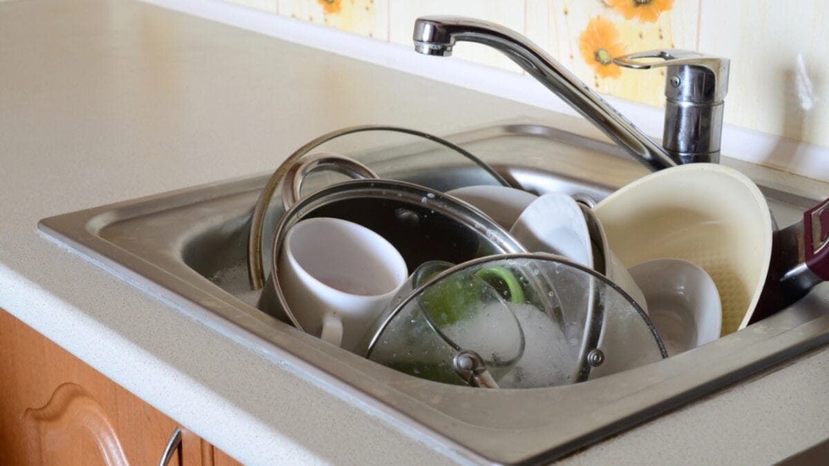 34 Mistakes to Avoid if You Want to Sell Your House 18 34 Mistakes to Avoid if You Want to Sell Your House - dirty plates in sink dp193018876