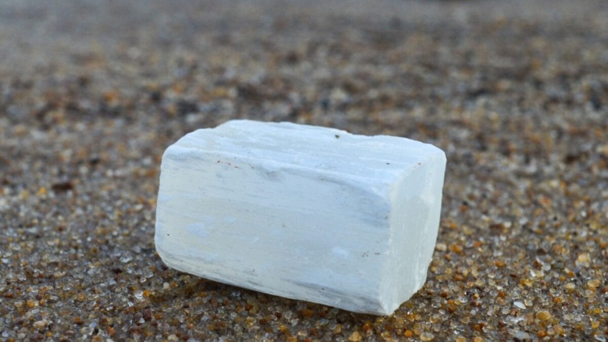 Are You a Magnet for Negativity? Use These 8 Crystals to Help Ward off Bad Vibes 5 Are You a Magnet for Negativity? Use These 8 Crystals to Help Ward off Bad Vibes - selenite on beach mineral Ss2331238725