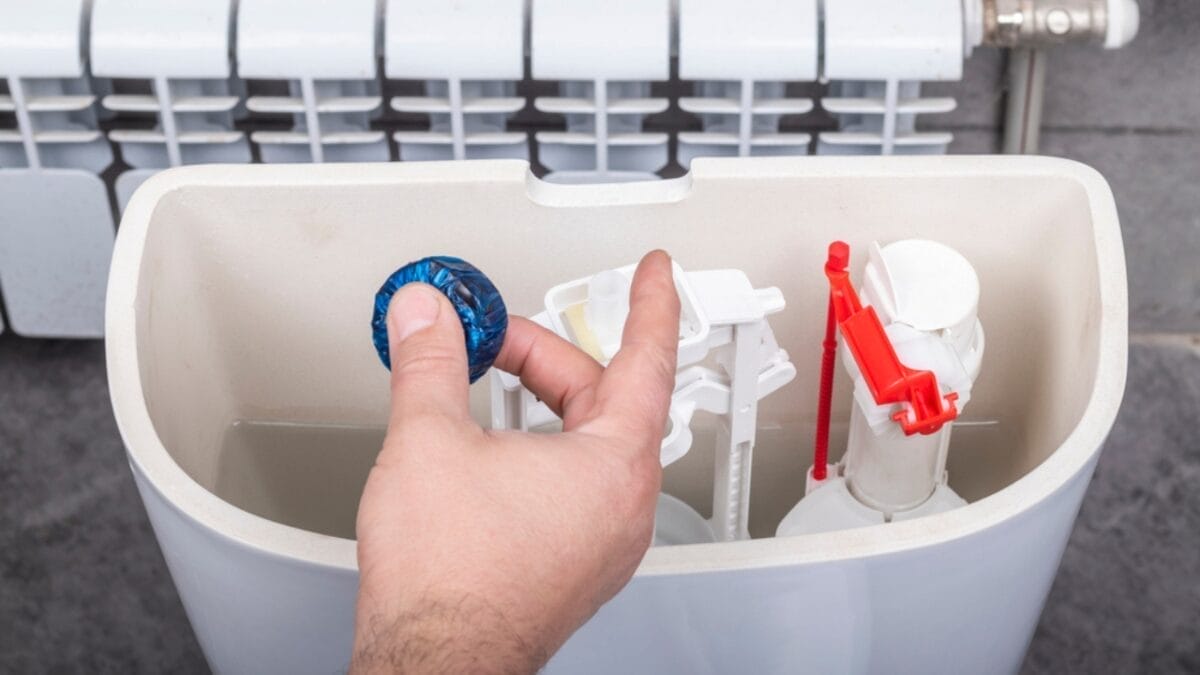 Ditch Your Toilet Brush—Try This Baking Soda Hack Instead 5 Ditch Your Toilet Brush—Try This Baking Soda Hack Instead - toilet tank with blue tablet dp442650402