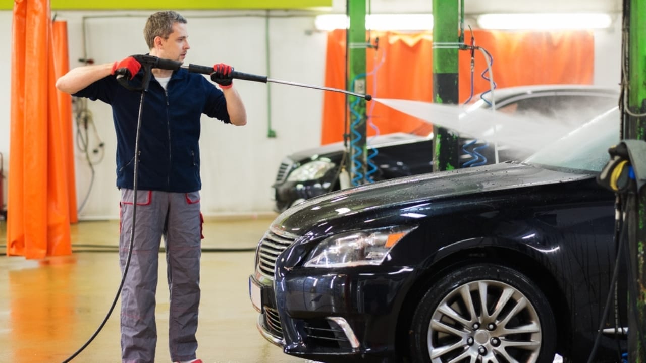 Automatic Car Washes May Be Costing You More Than You Think 4 Automatic Car Washes May Be Costing You More Than You Think - Man worker car wash dp57138837