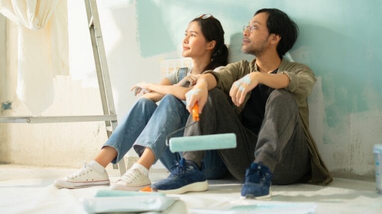 10 Paint Colors That Make Your House Look Dated & What to Use Instead 10 10 Paint Colors That Make Your House Look Dated & What to Use Instead - couple painting wall ss2326883265