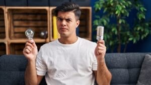 LED Light Bulbs & Incandescent Bans Aren't Lighting Up Consumers' Lives as Intended 1 LED Light Bulbs & Incandescent Bans Aren't Lighting Up Consumers' Lives as Intended - man holding led ss2233622021