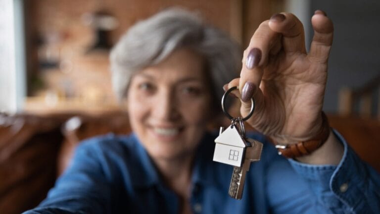 15 Jobs That Come With a Home to Get You Through the Housing Crunch 10 15 Jobs That Come With a Home to Get You Through the Housing Crunch - old woman with house key ss1822705970