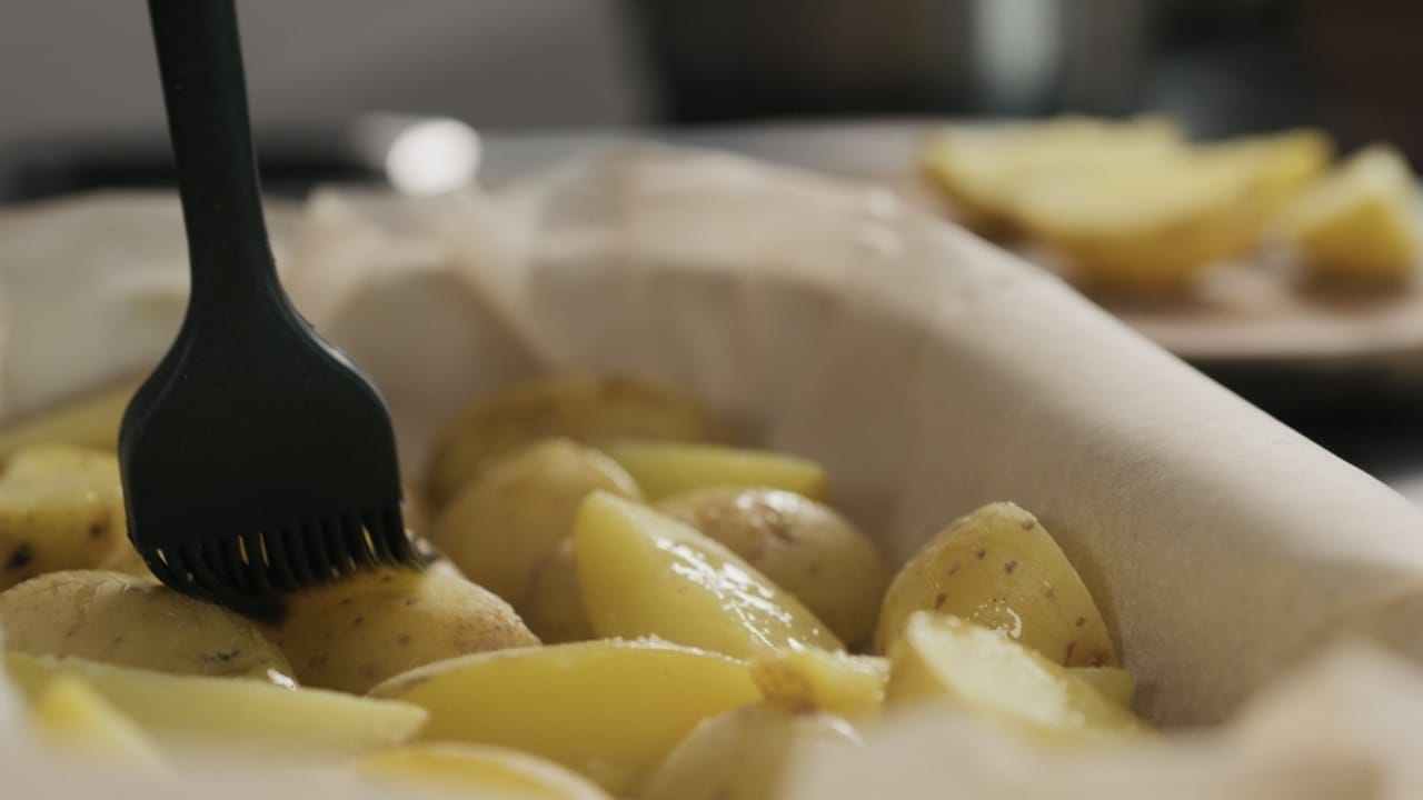 10 Tips for Baking Potatoes Like a Pro—And a Microwave Method When You’re in a Pinch 6 10 Tips for Baking Potatoes Like a Pro—And a Microwave Method When You’re in a Pinch - brush oil potato ss2258038169