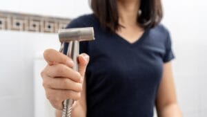 It's Time to Ditch Toilet Paper & Embrace the Bidet 1 It's Time to Ditch Toilet Paper & Embrace the Bidet - female holding bidet dp2464311701