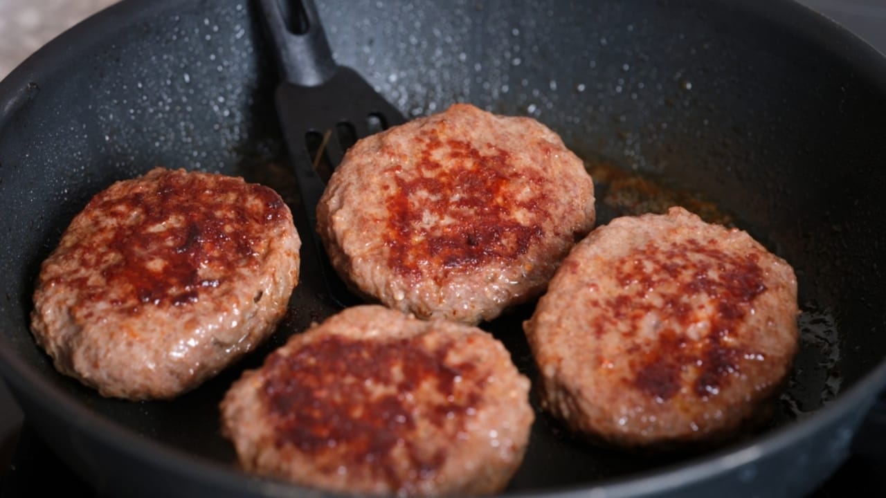 How to Make the Perfect Cast Iron Skillet Burger: 12 Pro Tips 10 How to Make the Perfect Cast Iron Skillet Burger: 12 Pro Tips - flipping beef patties ss2388371845