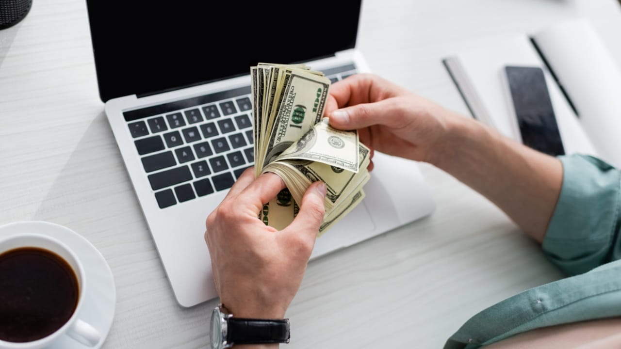 Why Leaving Your House to Your Children Could Be a Huge Mistake 12 Why Leaving Your House to Your Children Could Be a Huge Mistake - man holding money dp392215984