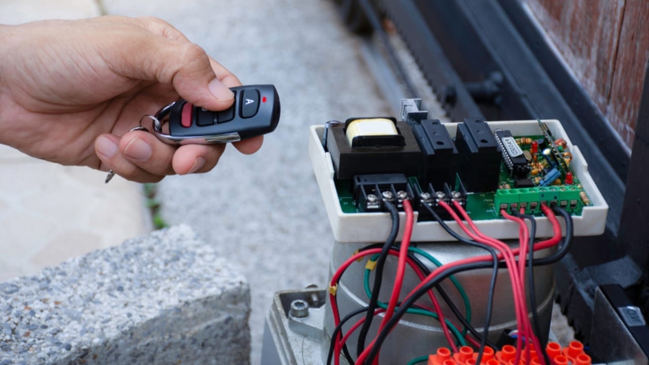 Homeowners, Don’t Skip These 15 Yearly Tasks to Save Serious Money Over Time - repairman checking automatic garage door ss1604119378