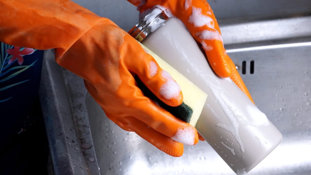 The Dirty Truth: What Happens If You Don’t Wash Your Water Bottle Regularly - washing water bottle battle with soap ss1955088433