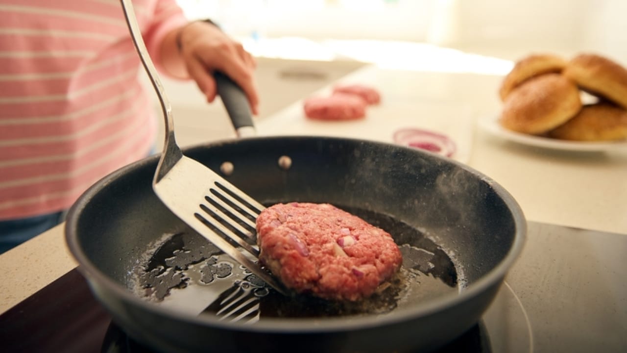 How to Make the Perfect Cast Iron Skillet Burger: 12 Pro Tips 9 How to Make the Perfect Cast Iron Skillet Burger: 12 Pro Tips - woman cooking beef patty ss2462264323