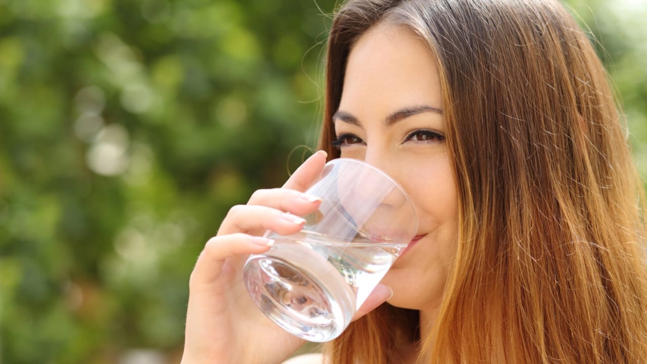 Sun Water: The Forgotten Elixir to Naturally Boost Your Health 2 Sun Water: The Forgotten Elixir to Naturally Boost Your Health - woman drinking water dp48959805