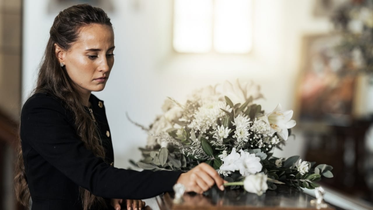 12 Heartfelt Ways to Support Someone Grieving the Loss of a Pet 10 12 Heartfelt Ways to Support Someone Grieving the Loss of a Pet - woman in funeral ss2225083801