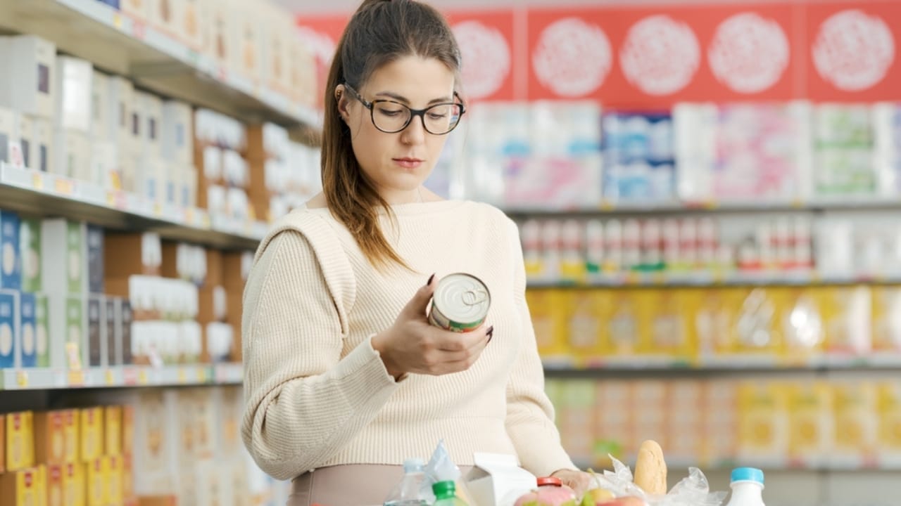 Don't Be Misled by Food Dates: Here's What They Truly Mean 4 Don't Be Misled by Food Dates: Here's What They Truly Mean - woman in grocery checking product label ss2400835171