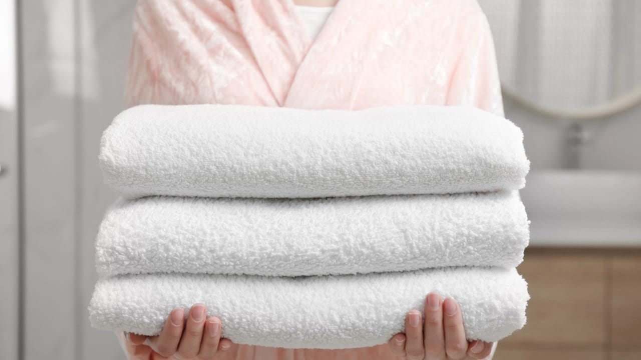 10 Indulgent Items for a Truly Luxurious Shower Experience - woman with Plush Towels Bathrobe dp341964854