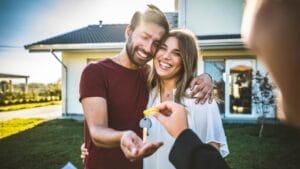 Why Leaving Your House to Your Children Could Be a Huge Mistake 1 Why Leaving Your House to Your Children Could Be a Huge Mistake - couple receiving keys of house from realtor ss2234397689