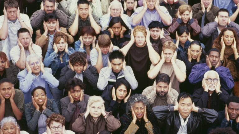 15 Stealth Strategies to Survive & Thrive in Urban Chaos 1 15 Stealth Strategies to Survive & Thrive in Urban Chaos - crowd covering ears ss146263625