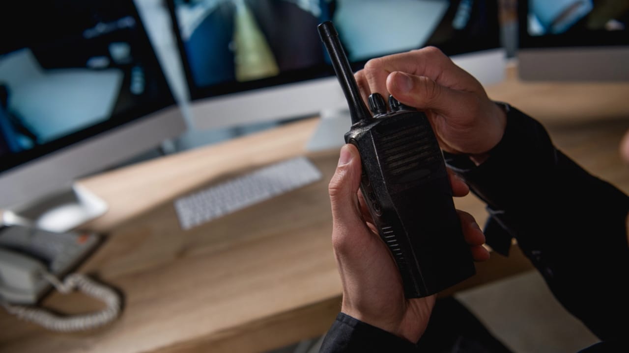 25 Everyday Inventions You Didn't Know Came from Military Innovations 13 25 Everyday Inventions You Didn't Know Came from Military Innovations - guard holding walkie talkie dp246311088