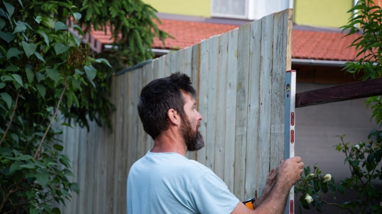 Homesteaders Don’t Hibernate: 20 Winter Activities That Matter Most 10 Homesteaders Don’t Hibernate: 20 Winter Activities That Matter Most - man making a wooden fence ss2470645329