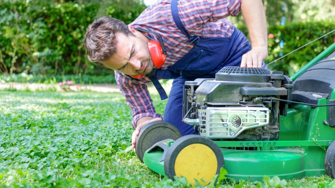 Old Lawnmower Gas— Here’s How to Safely Get Rid of It 3 Old Lawnmower Gas— Here’s How to Safely Get Rid of It - man repairing lawn mower dp392125454