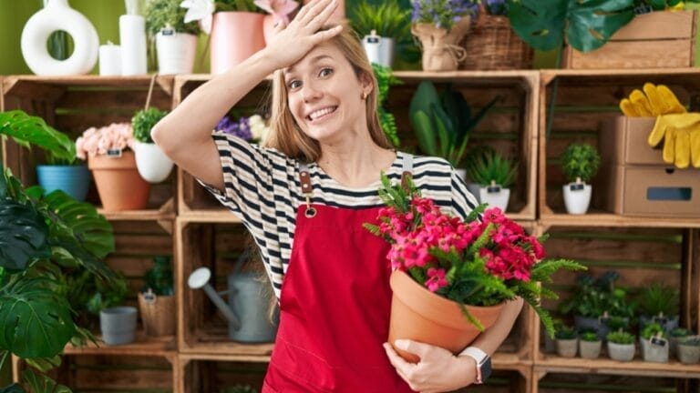 10 Common Orchid Plant Care Mistakes That Make Florists Cringe 1 10 Common Orchid Plant Care Mistakes That Make Florists Cringe - stressed woman holding plant ss2416933471