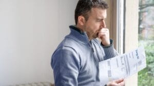 How One Man Outsmarted the Power Company & Got Them to Cover His Bill 1 How One Man Outsmarted the Power Company & Got Them to Cover His Bill - stressed worried man reading energy bill ss2125548260