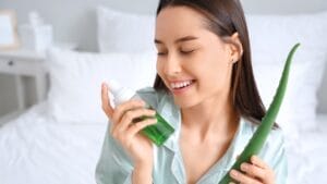 Aloe Vera for the Win: Why This Plant Should Be in Every Home 1 Aloe Vera for the Win: Why This Plant Should Be in Every Home - woman holding aloe vera and bottle of cosmetic product ss2495985285
