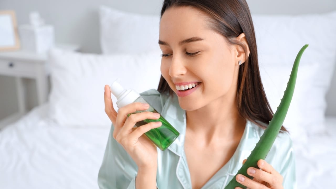 12 Reasons Aloe Vera Is a Wellness Must-Have 4 12 Reasons Aloe Vera Is a Wellness Must-Have - woman holding aloe vera and bottle of cosmetic product ss2495985285